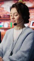 Vertical Friendly customer support workers respond to customers inquiries about products or services. Cheerful call center agent in office providing accurate and satisfactory information to customers, camera B video