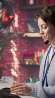 Vertical Call center employee handling customer complaints, assisting with technical issues. Customer service agent contacts clients to inform them about products promotions, camera A video