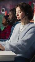 Vertical Account manager in office talking in headset mic, maintaining strong client relationships through regular communication. Employee talking with customer, Identify new sales opportunities, camera B video