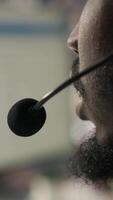 Vertical Closeup of call center agent providing support, handling clients complaints, speaking in audio headset mic. Employee dealing with unsatisfied customers, talking in headphones mic, camera A video