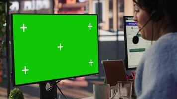 Call center agent helping customers regain access to accounts using green screen mockup PC. Employee in customer center assisting clients needing help, working on chroma key computer, camera A video