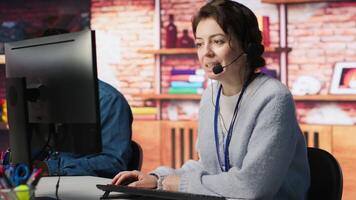 Call center employee handling customer complaints, offering helpful solutions to their concerns. Customer service agent providing helpful information related to products or services, camera A video