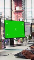 Vertical Call center agent providing live chat support using green screen PC, handling clients complaints. Employee using chroma key computer, dealing with unsatisfied customers, camera B close up video