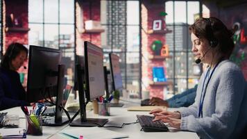 Joyous call center agent providing step by step guidance to resolve customers concerns. Happy customer center worker diagnosing problems, walking clients through technical solutions, camera B video