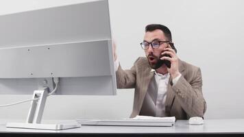 Frustrated businessman talking on phone, having serious problems while his co-workers making him feels guilty for not doing his job properly at office. Business conflict and overwork concept video