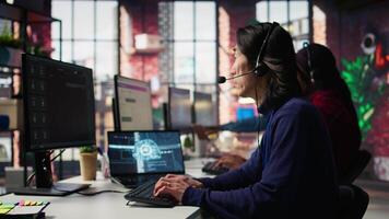 Customer center employee uses artificial intelligence LLM assistant to locate clients packages. Call center agents track shipments in office, using AI chatbot to generate solutions, camera B video