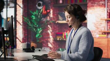 Call center employee handling customer complaints, assisting with technical issues. Customer service agent contacts clients to inform them about products promotions, camera A video