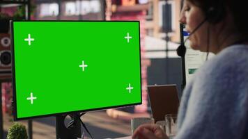 Call center agent providing live chat support using green screen PC, handling clients complaints. Employee using chroma key computer, dealing with unsatisfied customers, camera A close up video