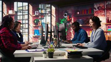 Call center employee handling customer complaints, offering helpful solutions to their concerns. Customer service agent providing helpful information related to products or services, camera B video