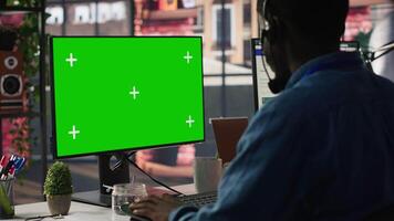 Call center agent using mockup green screen PC, providing step by step guidance to customers. Happy customer center worker using chroma key computer, diagnosing problems for clients, camera A video