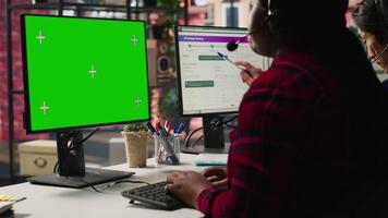 Call center agents tracking shipments in office using green screen computer. Customer center workers use chroma key PC to locate clients packages and provide status updates, camera A video