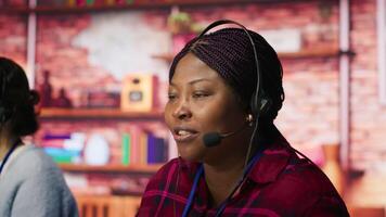 Smiling call center agent assisting customers through digital communication channels. Customer support employee using computer to have conversation with client in live chat, camera A video