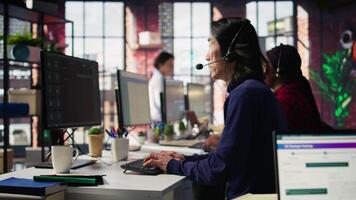 Call center agent using AI chatbot to provide quick and accurate replies to common customer queries. Customer service representative generating automated responses to clients using AI, camera B video