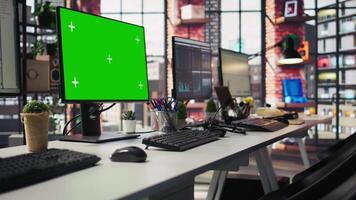 Isolated screen computer displays in customer support workplace, panning shot. Chroma key PC monitors in empty call center office where unsatisfied customers call to solve technical problems video