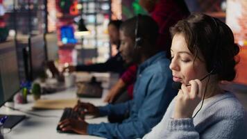 Call center employee handling customer inquiries, complaints and support requests in office. Customer service representative assisting customers with issues related to products or services, camera B video
