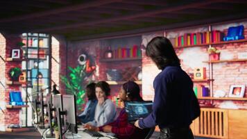 Call center senior engineer arriving at work, using AI, helping customers regain access to accounts. Customer center technician at desk using artificial intelligence, assisting clients, camera B video