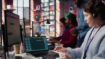 Call center agent uses AI chatbot on laptop to provide quick and accurate replies to common customer questions. Customer service worker generates automated responses using AI LLM on notebook, camera B video
