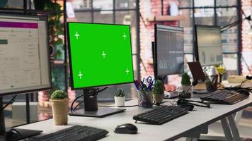 Green screen PC monitors in empty call center office where unsatisfied customers call to solve technical problems. Mockup computer displays in customer support workspace, panning shot video