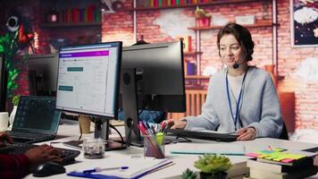 Portrait of smiling call center agent next to coworkers tracking shipments in office, solving tasks. Joyous worker and colleagues in customer center locate clients packages and provide status updates video