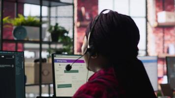 Call center worker in office using AI chatbot to provide quick replies to common customer queries. Woman doing customer service job generating automated responses to clients using AI, camera A video