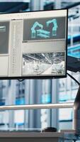 Vertical Monitor in industry 4.0 industrial plant used to oversee operation of robotic arms and conveyor systems. Close up of display in smart factory used to monitor system performance video
