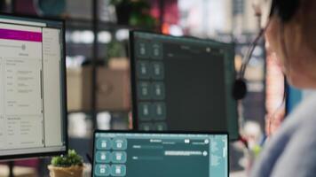 Call center agent uses AI chatbot on laptop to provide quick and accurate replies to common customer questions. Customer service worker generates automated responses using AI LLM on notebook, camera A video