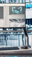 Vertical Monitor in automated photovoltaics factory running Industry 4.0 monitoring system, analyzing IoT sensor data. Predictive maintenance done using device for smart solar panel production efficiency video