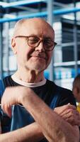 Vertical Portrait of jolly senior engineer in industry 4.0 industrial plant installing machinery, conducting thorough testing. Upbeat elderly man in smart factory calibrating IoT sensors video