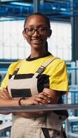 Vertical Portrait of happy smart factory engineer working on predictive maintenance algorithms to enhance productivity. Cheerful industry 4.0 plant technician overseeing facility floor video