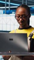 Vertical Engineer in industry 4.0 industrial plant installing machinery on production line, conducting thorough testing. Robotics technician in smart factory calibrating IoT sensors video