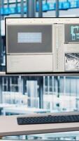 Vertical Monitor in smart photovoltaics factory displaying real time system performance metrics. Display in industry 4.0 solar panels plant tracking energy production and efficiency through IoT sensors video