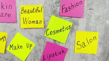 Conceptual idea about cosmetology. Makeup components in selfcare. Creating an attractive image for girl with the help of cosmetics and fashion salon. Sticky notes with words about cosmetics video