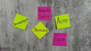 Sticky notes with handwritten words about the importance of taking care of your body. Conveys reminder of the of skin care. In the mood for visit to the dermatologist. Cosmetology project video