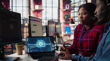 Call center coworkers in office helping customers regain access to accounts using AI, resetting passwords. Colleagues in customer center assisting clients needing help using artificial intelligence video