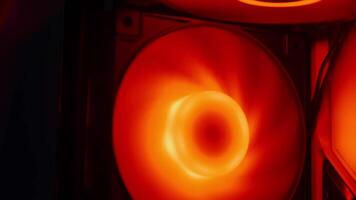 Inside view of a computer with flashing bright red RGB LED backlighting. Gaming computer with warning red light video