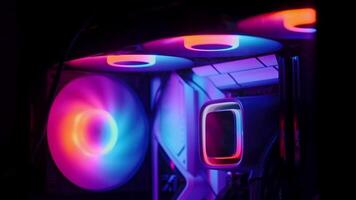 Inside view of a custom gaming PC with vibrant rainbow RGB LED lighting. Computer equipment. video