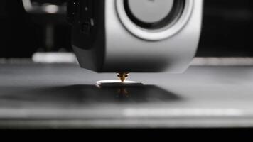 A 3D printer portal with a carriage and a print head of a 3D printer that prints with white plastic on a printing platform. additive manufacturing concept video