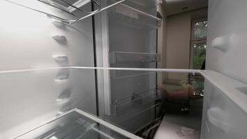When hungry, a man looks into the refrigerator and checks that it is empty. POV point of view from inside the kitchen fridge video