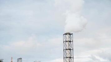 a factory with smoke coming out of it. pipe from which smoke comes, environmental pollution. video