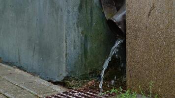 Rainwater flows down a drainpipe when it rains. rain drainage pipe. video