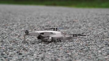 View of a small quadcopter taking off from the ground. Drone takes off from the road video