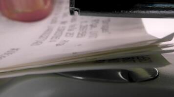 Document flow. Close up of girl hands using stapler on documents over a desk. video