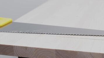 A Man sawing a wooden beam. Building a house with your own hands. video