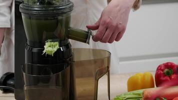 Drains vegetable juice from a juicer. Healthy detox vegetarian diet with cold pressed plant extractor for bread and smoothies. video