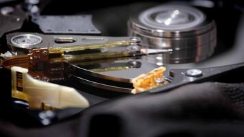 Open hard drive with head for reading data. Reading head of a disassembled HDD. video