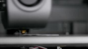 The 3D printer prints a unique product from white plastic. Working 3D printer head. video