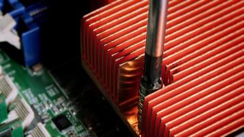 Screwing on the processor heatsink. Close-up of the chipset heatsink on the motherboard video