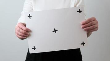 woman holding a sheet of blank paper. Empty layout for the ad. video