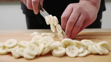 a man cuts fruits to prepare a nutritious smoothie for an organic diet at home. video