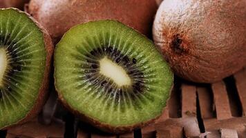 ripe kiwi on a straw background. detoxifying smoothie ingredient video